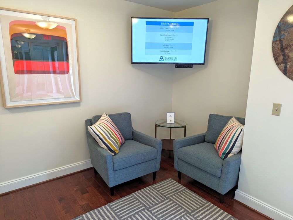 Office Waiting Room With Sofas & Directory Display on TV